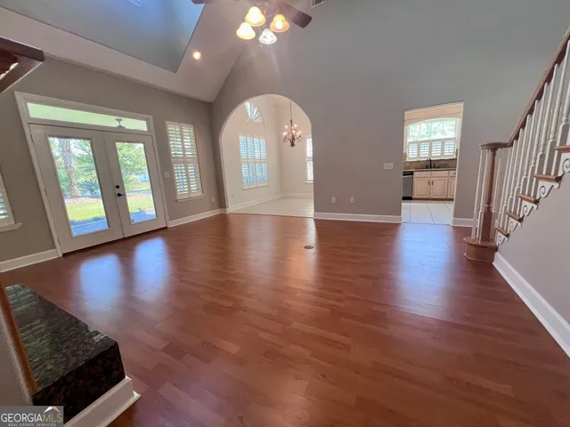 a view of an entryway with wooden floor windows and a fireplace