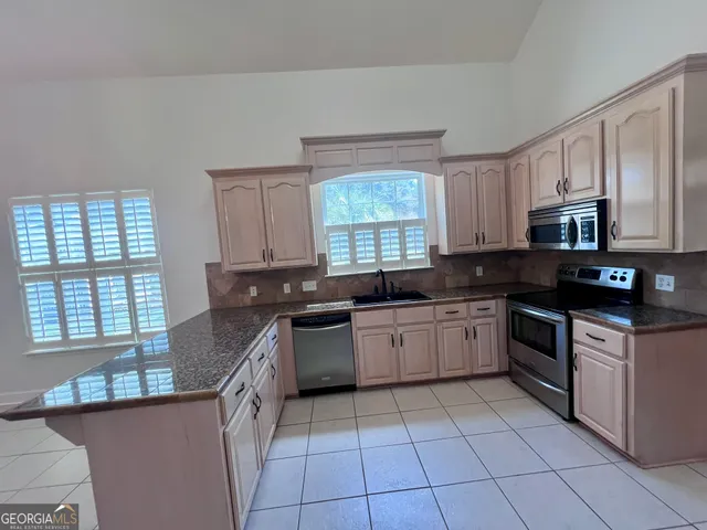 a kitchen with a sink stove and cabinets