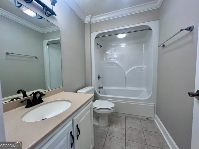 a bathroom with a granite countertop sink toilet a mirror and shower