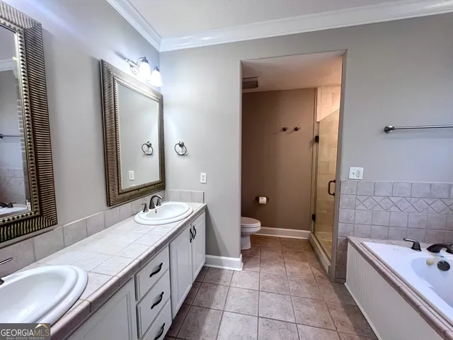 a bathroom with a tub sink and mirror