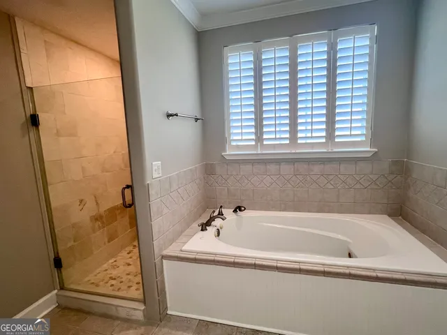 a white bath tub sitting next to a shower