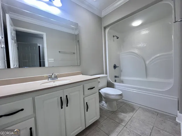 a bathroom with a double vanity sink toilet and shower