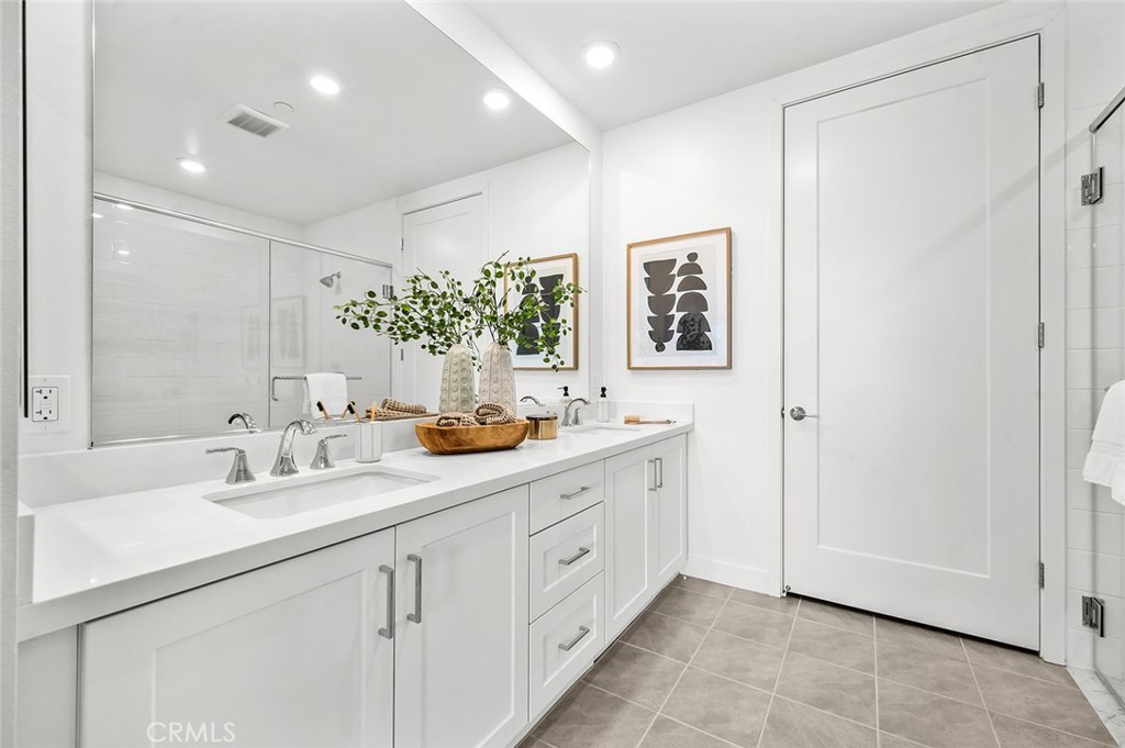 3604 Rivington Irvine, CA 92612 - Photo 20 of 54 a bathroom with a double vanity sink and a mirror