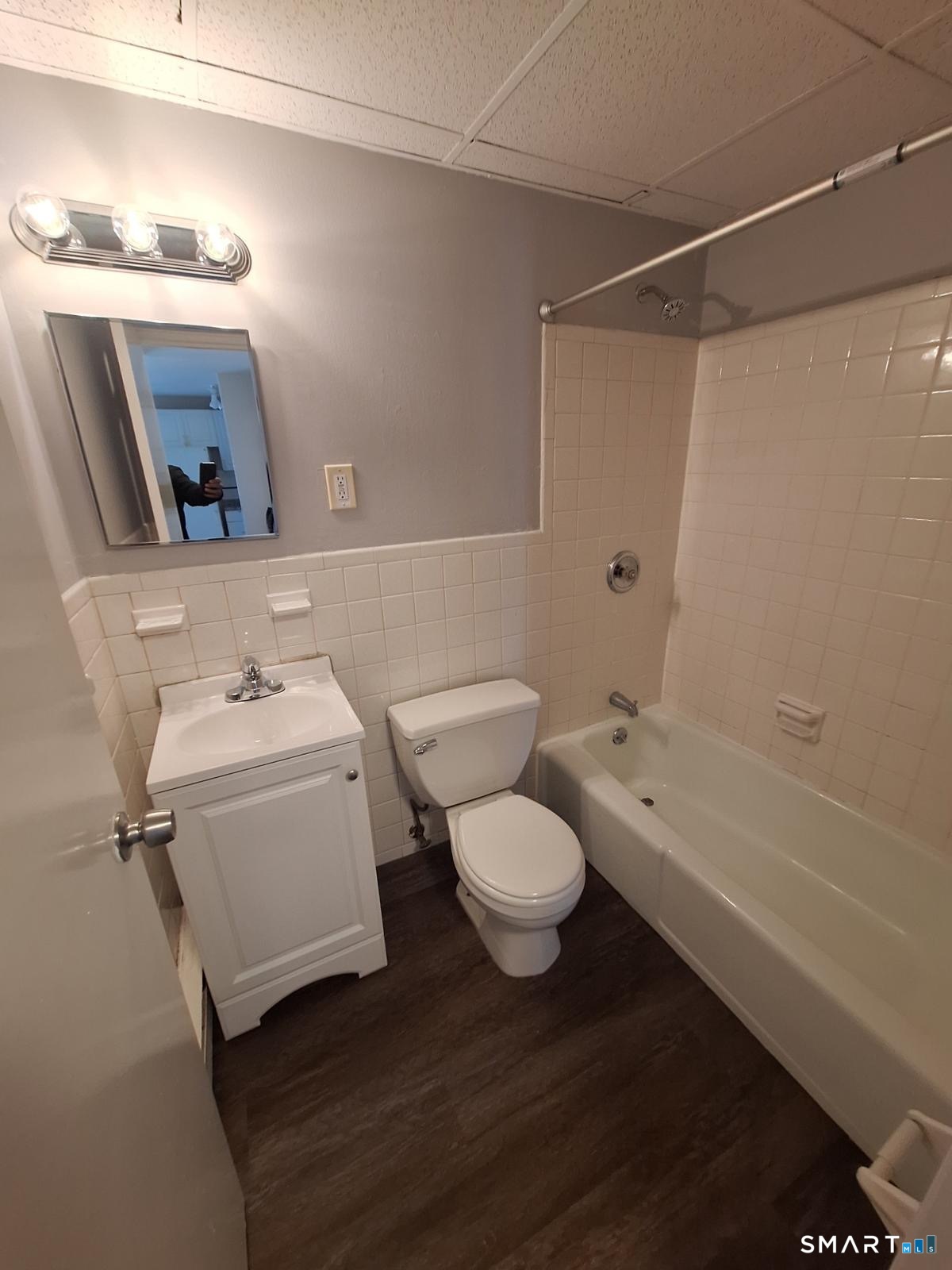 217 Hollister Avenue, Unit A2 Bridgeport, CT 06607 - Photo 6 of 6 a bathroom with a sink and a mirror