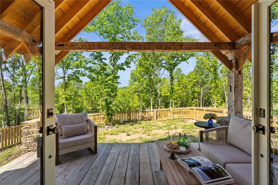 425 Barnhardt Road Timbo, AR 72680 - Photo 29 of 60 Expansive covered porch featuring exposed timber framing and wood-finish decking