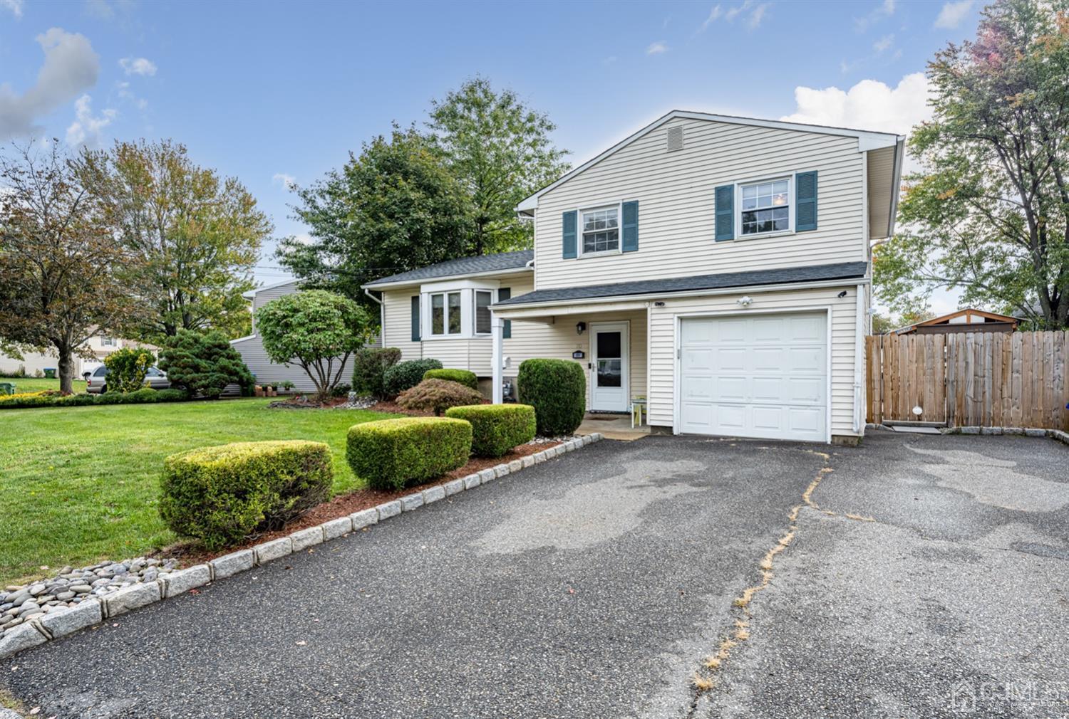 20 Outcalt Road Edison, NJ 08817 - Photo 2 of 35 a front view of a house with a yard and garage