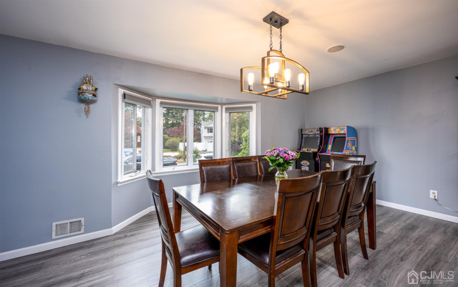 20 Outcalt Road Edison, NJ 08817 - Photo 20 of 35 a dining room with wooden floor a chandelier a wooden table and chairs