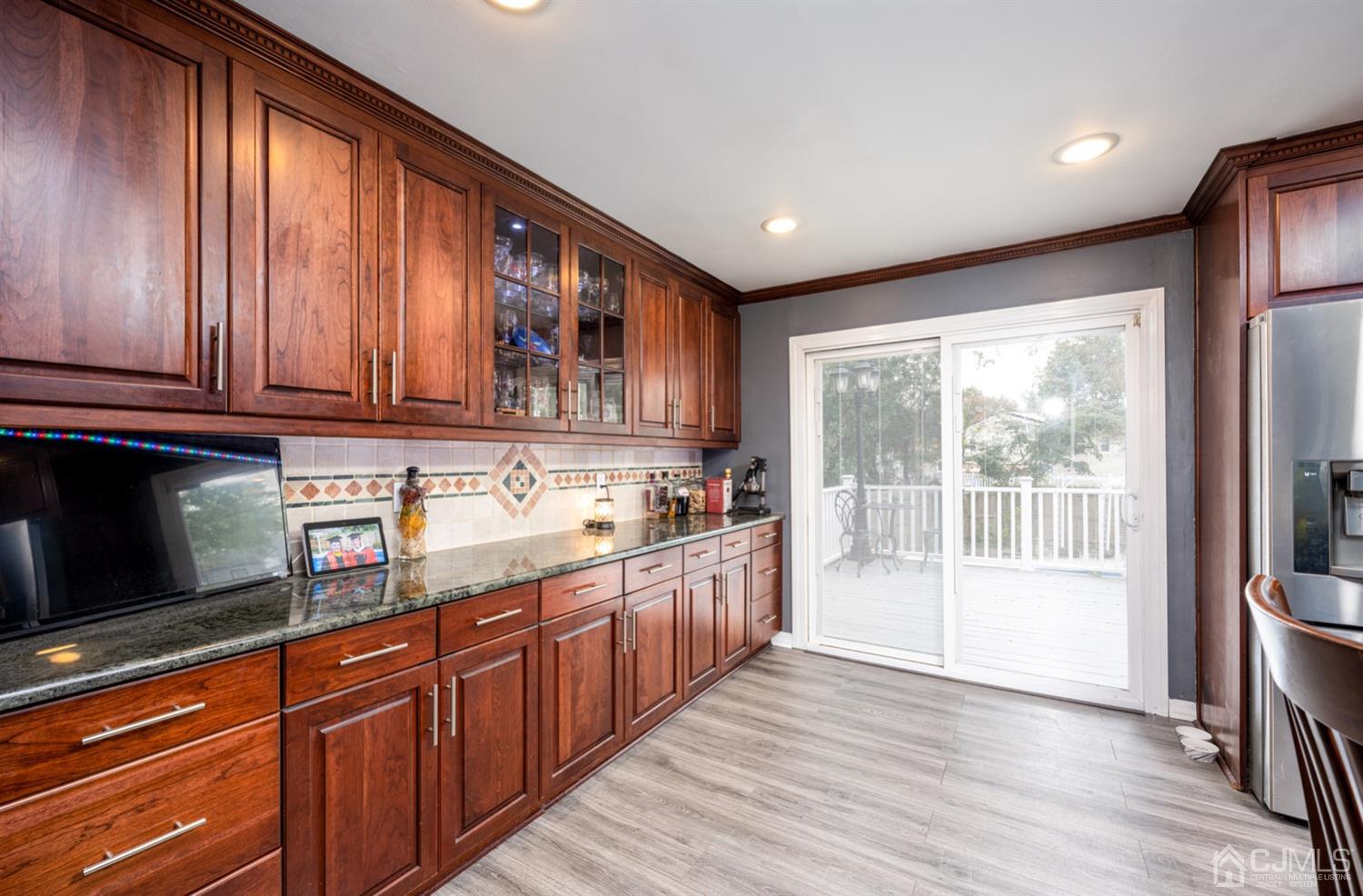 20 Outcalt Road Edison, NJ 08817 - Photo 24 of 35 a kitchen with stainless steel appliances granite countertop wooden cabinets a refrigerator and sink