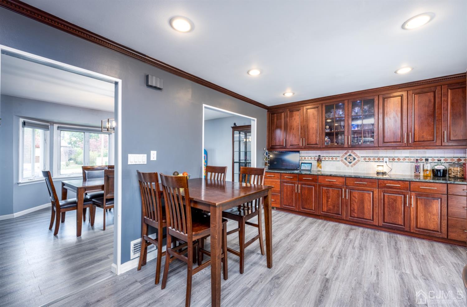 20 Outcalt Road Edison, NJ 08817 - Photo 25 of 35 a kitchen with stainless steel appliances granite countertop wooden floor wooden cabinets dining table and chairs