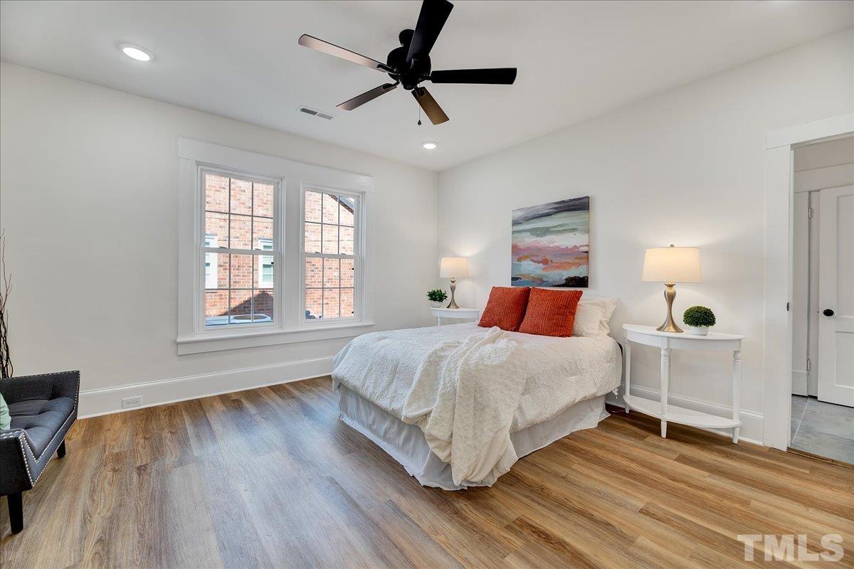 602 West Main Street Benson, NC 27504 - Photo 23 of 42 a bedroom with a bed and wooden floor