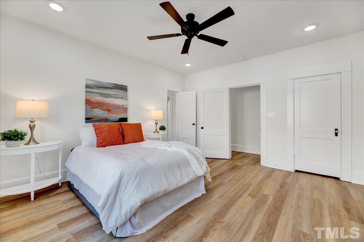 602 West Main Street Benson, NC 27504 - Photo 24 of 42 a bedroom with a bed and a chandelier