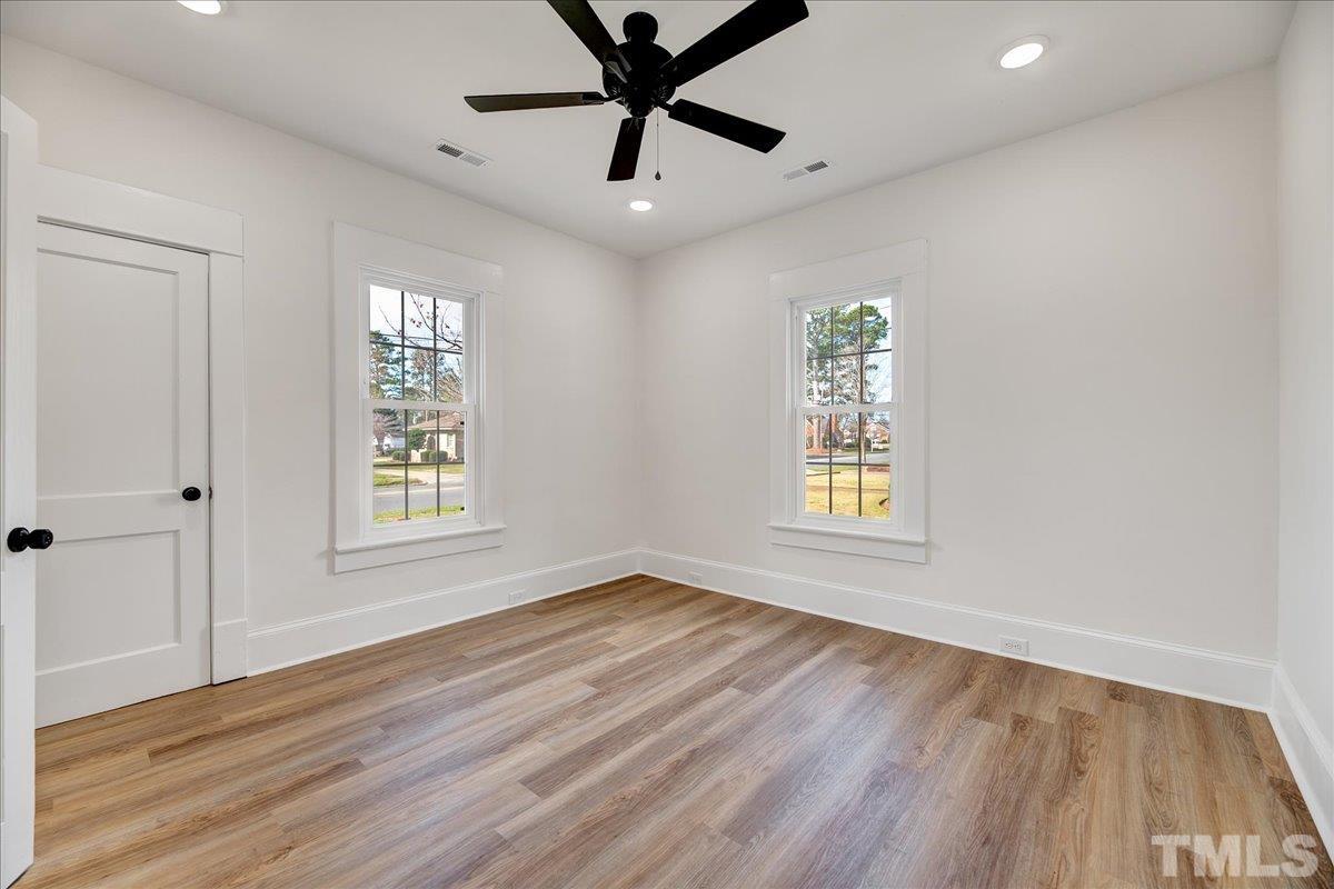 602 West Main Street Benson, NC 27504 - Photo 25 of 42 a view of an empty room with window and wooden floor