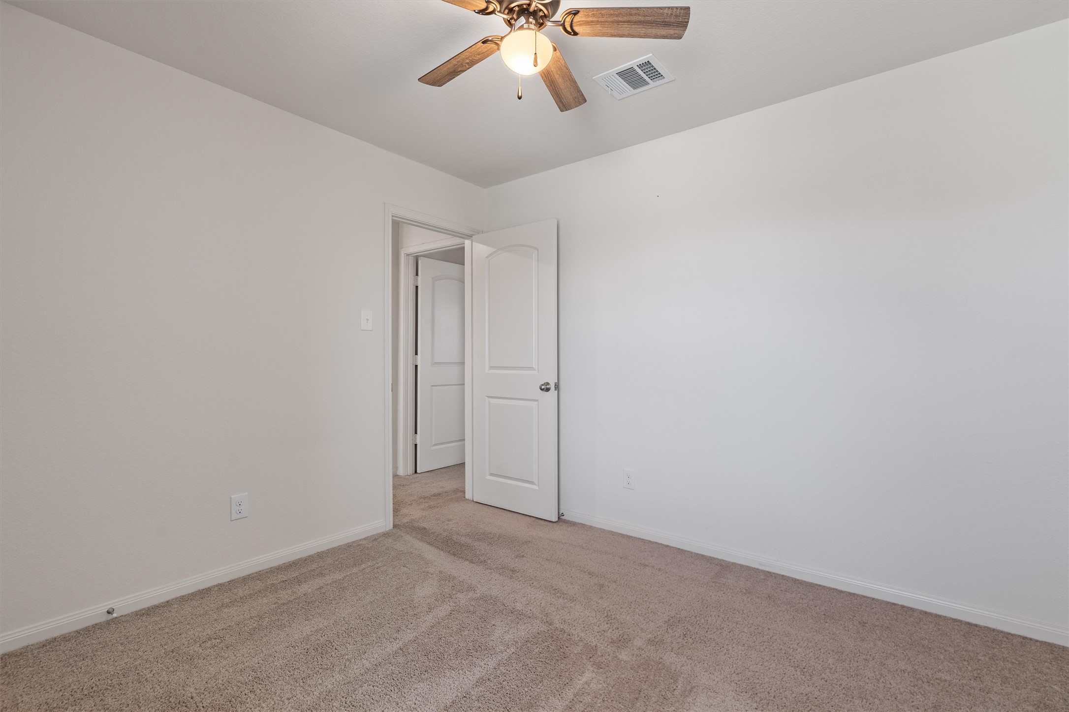 163 Niven Path, Unit 12K Jarrell, TX 76537 - Photo 21 of 39 Unfurnished room featuring light colored carpet and a ceiling fan.