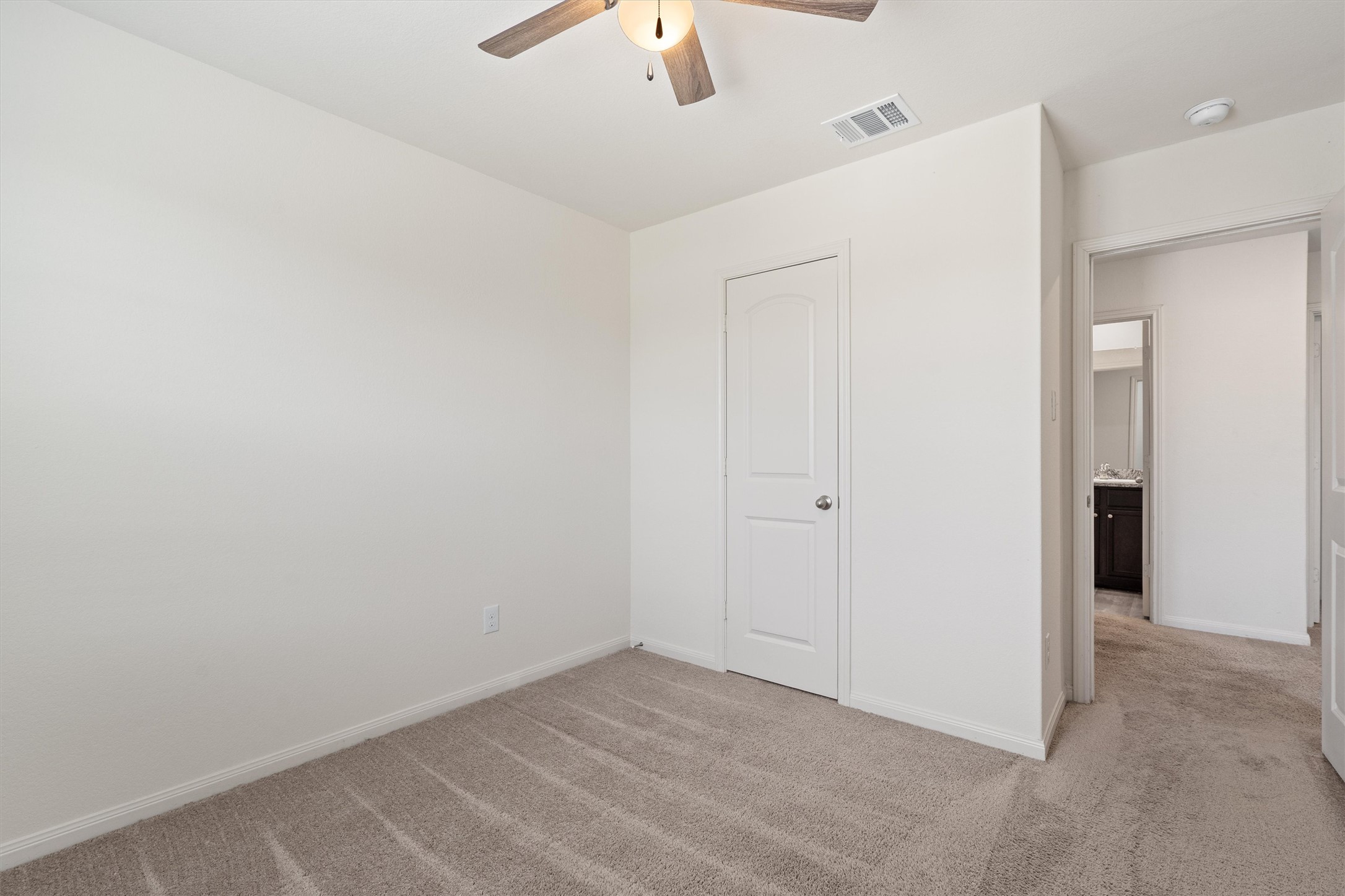 163 Niven Path, Unit 12K Jarrell, TX 76537 - Photo 25 of 39 Unfurnished bedroom featuring light carpet and ceiling fan,
