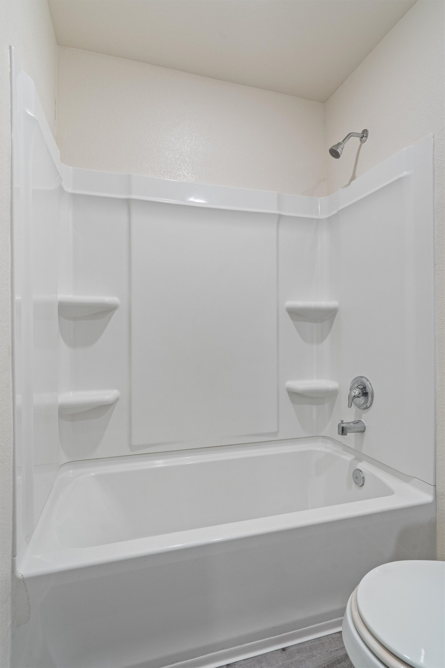 163 Niven Path, Unit 12K Jarrell, TX 76537 - Photo 26 of 39 Full bathroom featuring dark wood-type flooring and shower / bathtub combination