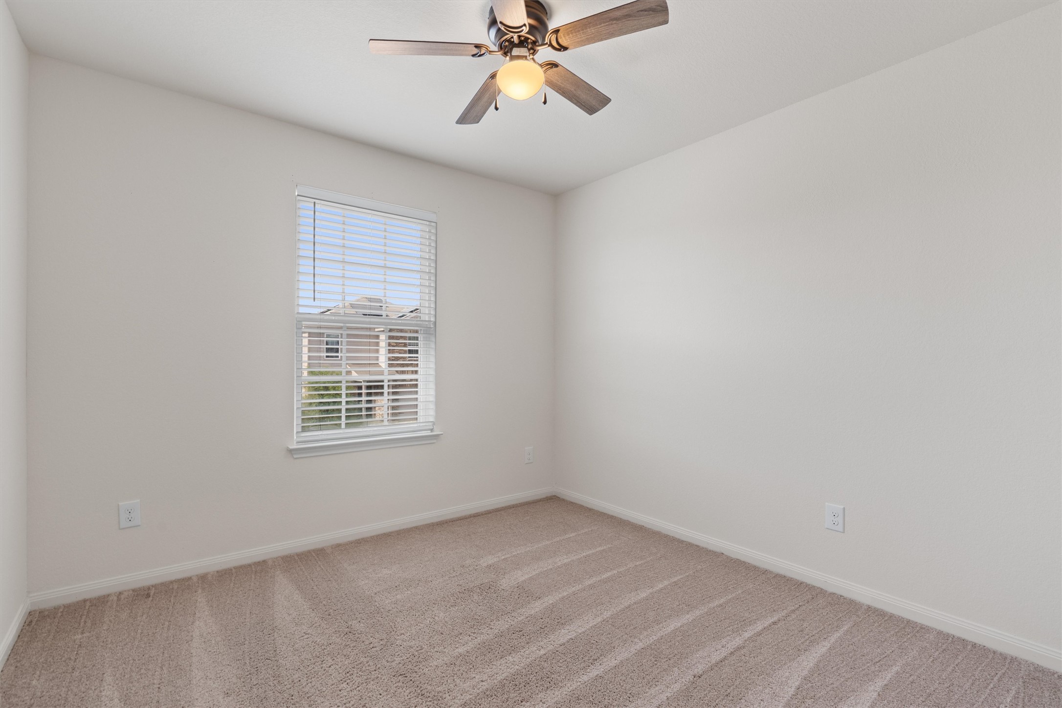163 Niven Path, Unit 12K Jarrell, TX 76537 - Photo 27 of 39 Unfurnished room featuring light carpet and ceiling fan and lots of natural light.