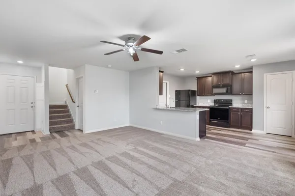 a view of kitchen with refrigerator and window