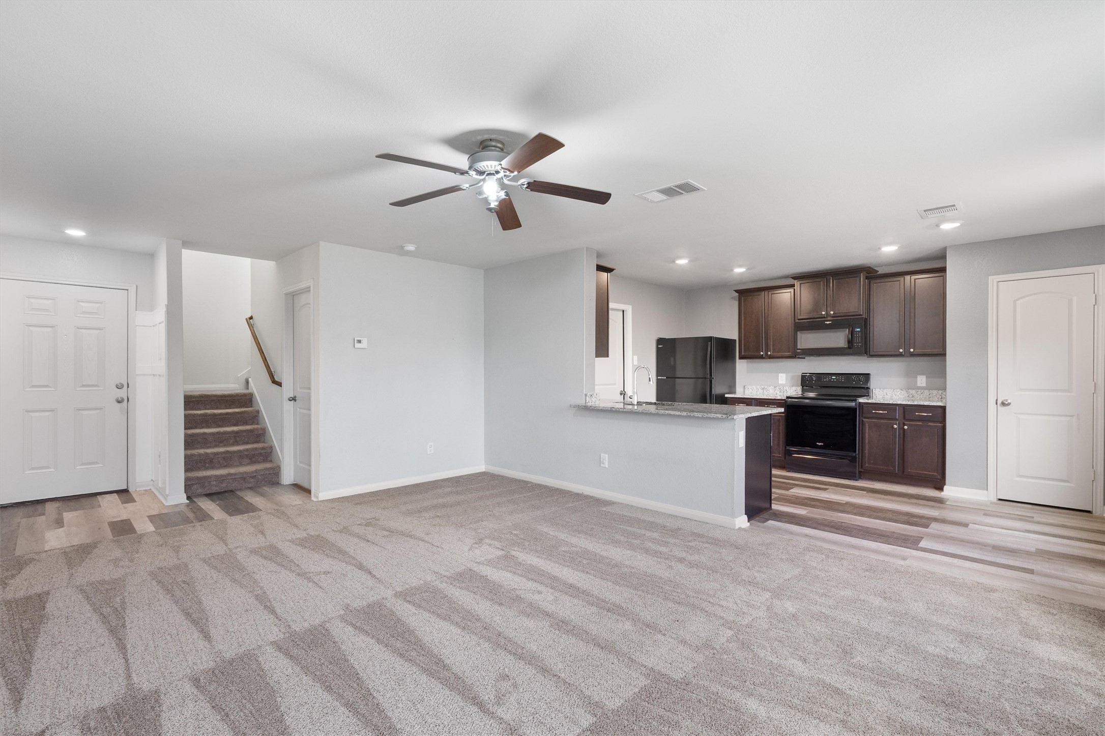 163 Niven Path, Unit 12K Jarrell, TX 76537 - Photo 4 of 39 living room with ceiling fan, light carpet, and recessed lighting