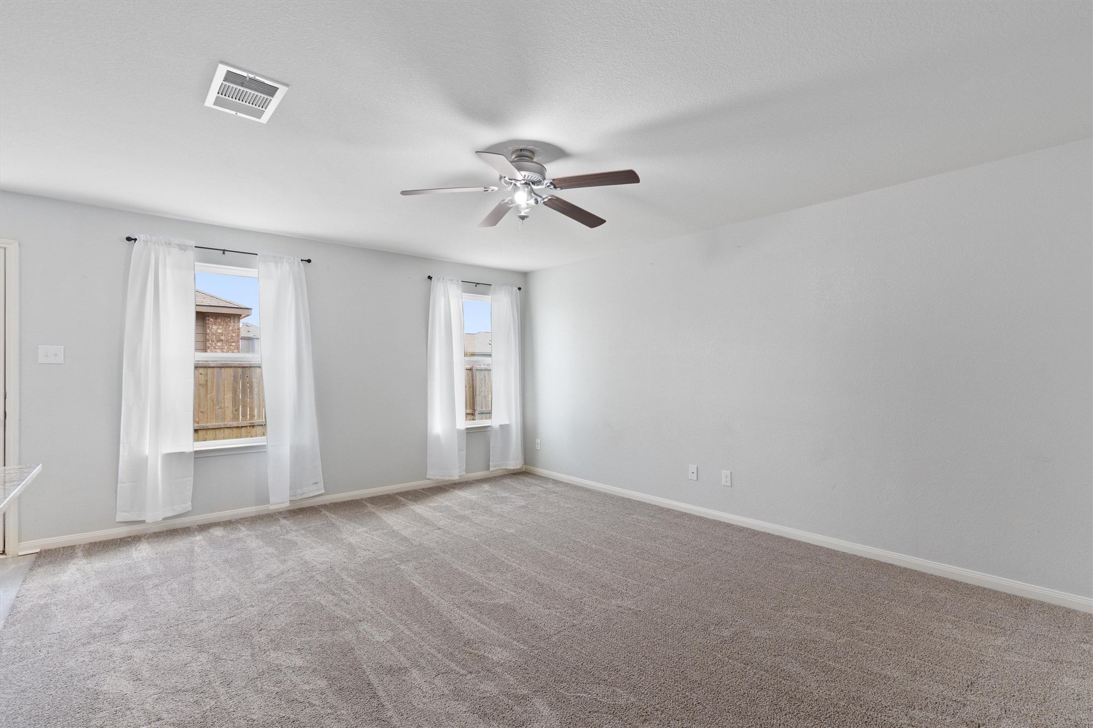 163 Niven Path, Unit 12K Jarrell, TX 76537 - Photo 5 of 39 View of the Living Room looking out towards the entry.