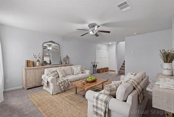 a living room with furniture and a chandelier