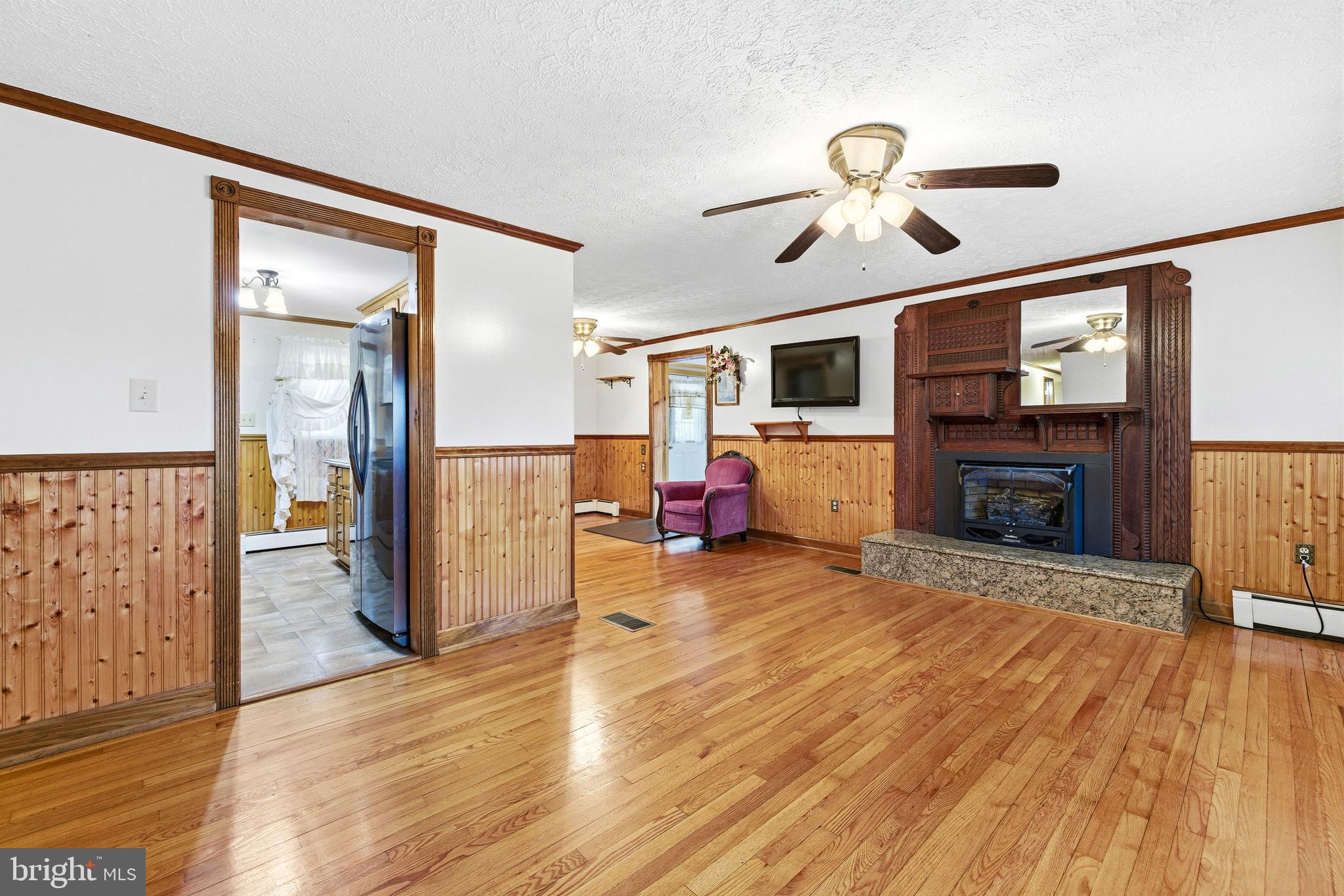 5009 Mill Creek Road Luray, VA 22835 - Photo 11 of 87 a view of a livingroom with wooden floor and a ceiling fan