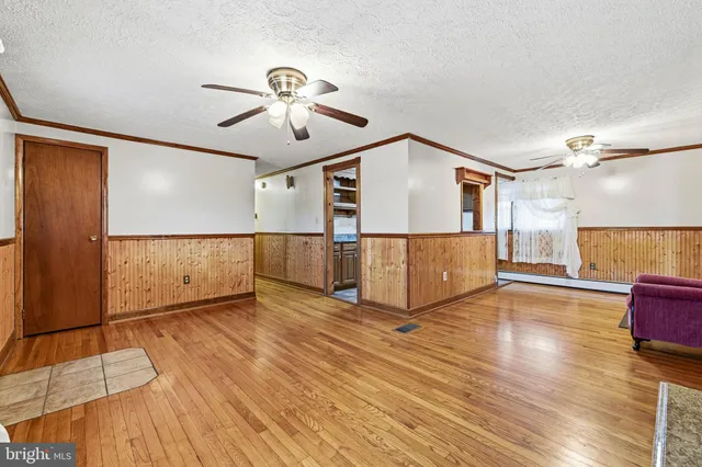 a bathroom with a granite countertop sink a mirror and shower