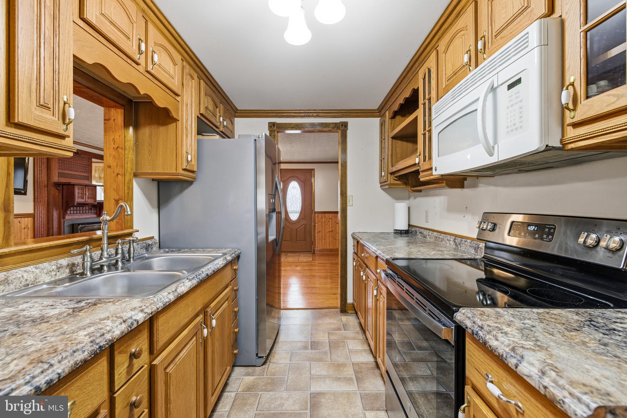 5009 Mill Creek Road Luray, VA 22835 - Photo 14 of 87 a kitchen with stainless steel appliances granite countertop a sink and a stove