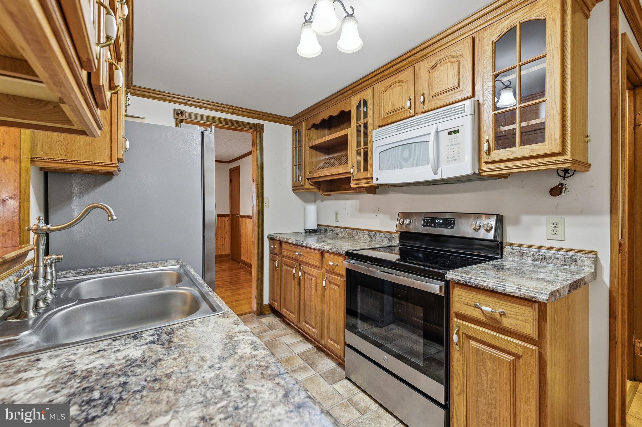 5009 Mill Creek Road Luray, VA 22835 - Photo 15 of 87 a kitchen with stainless steel appliances granite countertop a stove and a sink