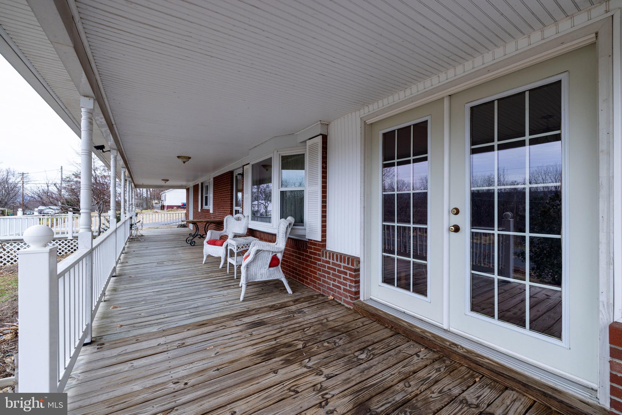 5009 Mill Creek Road Luray, VA 22835 - Photo 36 of 87 a view of a porch with wooden floor and iron stairs