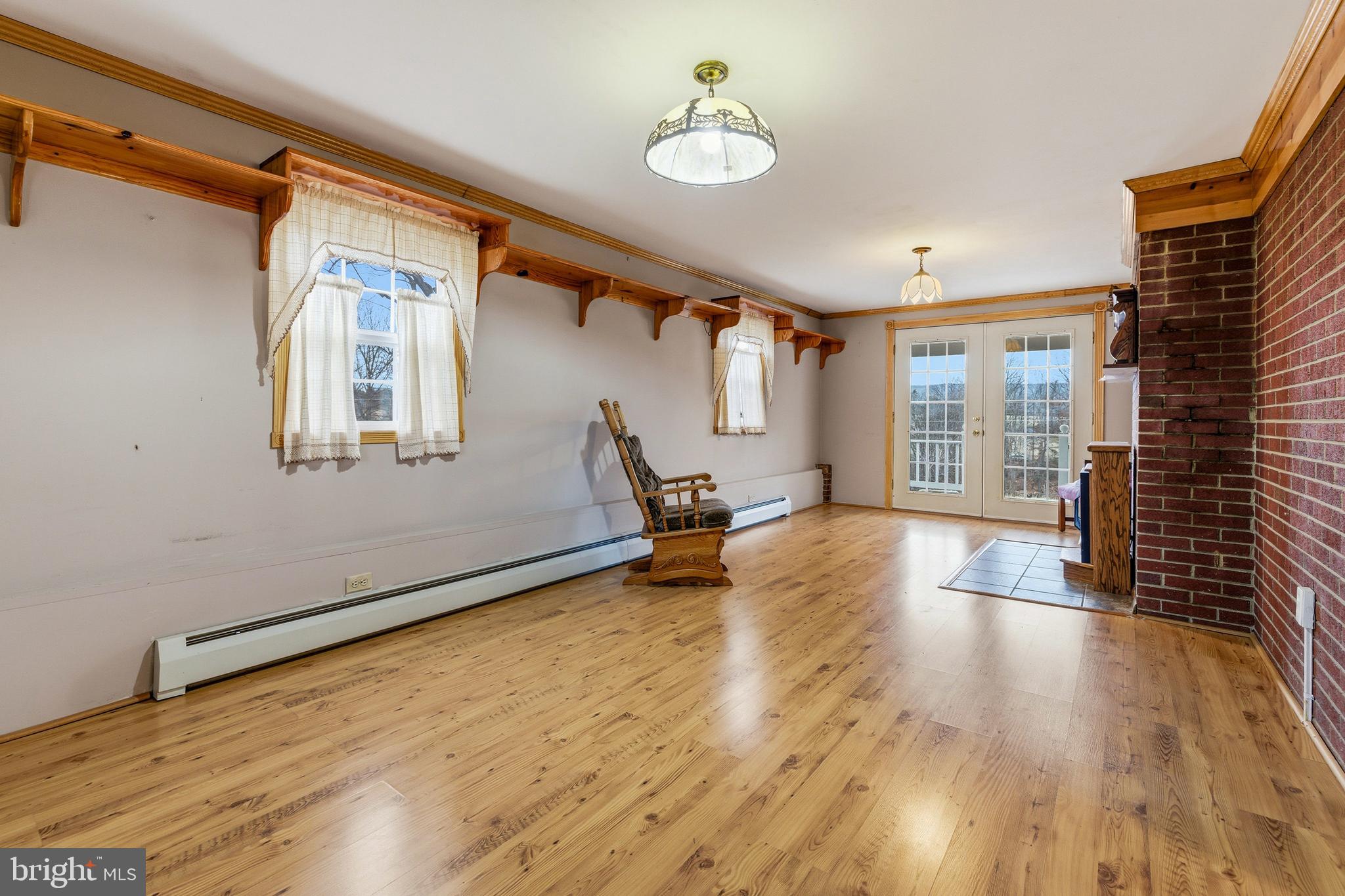 5009 Mill Creek Road Luray, VA 22835 - Photo 5 of 87 a view of an empty room with wooden floor and a window