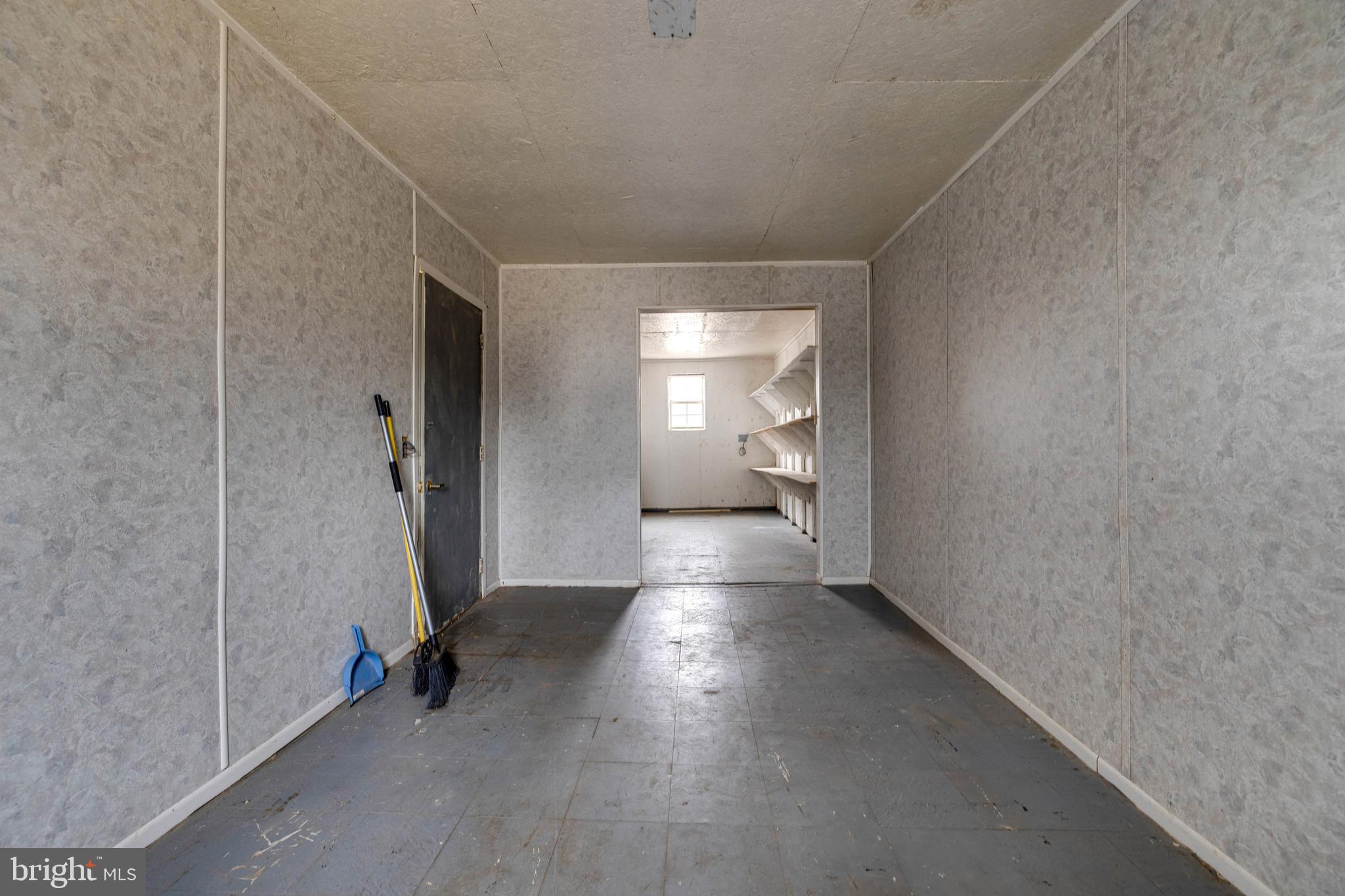 5009 Mill Creek Road Luray, VA 22835 - Photo 53 of 87 a view of a hallway with wooden floor and a bathroom