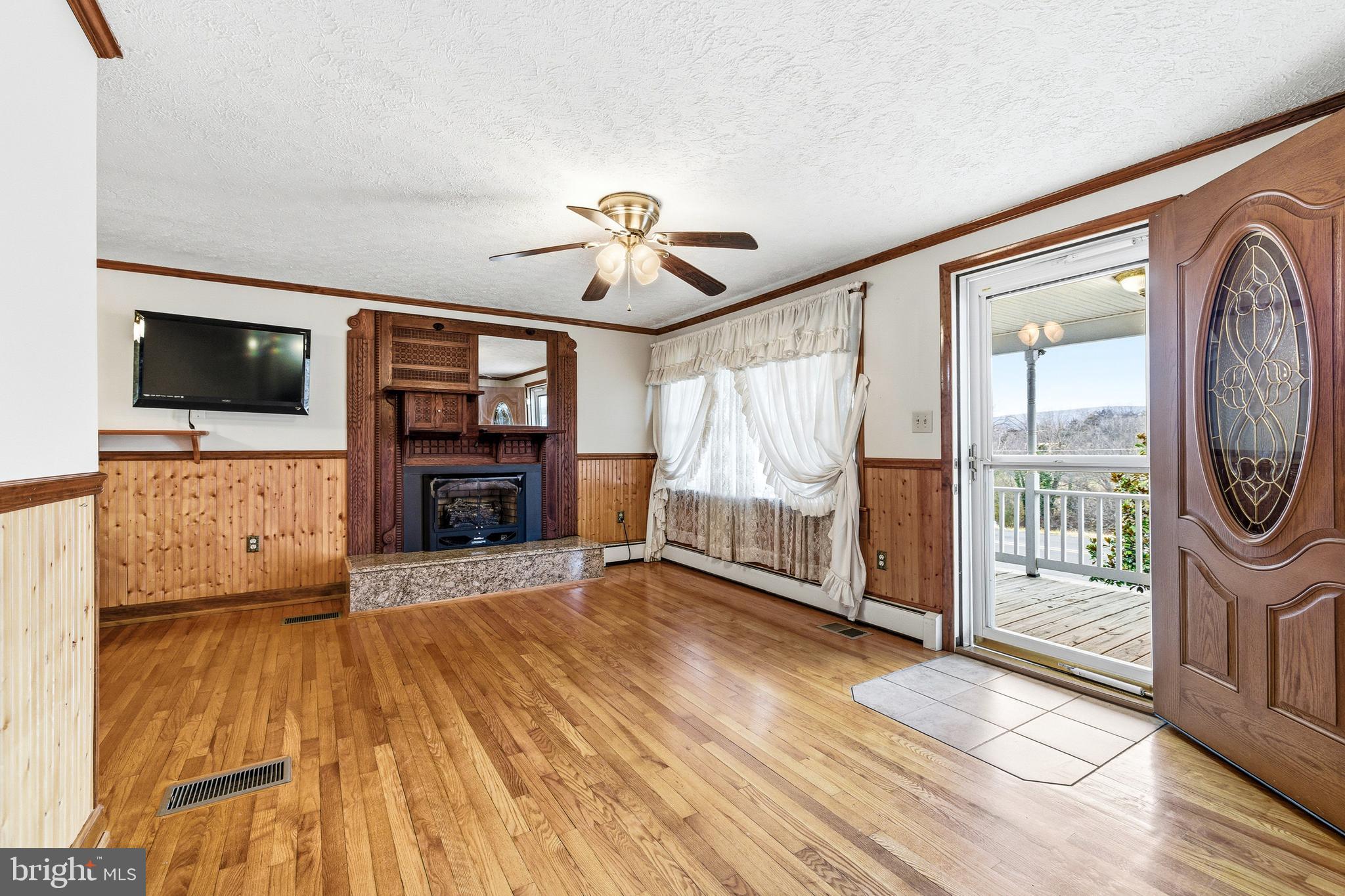 5009 Mill Creek Road Luray, VA 22835 - Photo 10 of 87 a view of a livingroom with wooden floor and a ceiling fan