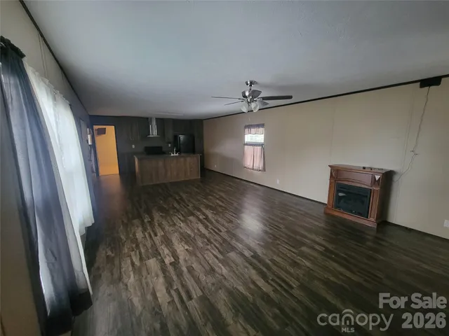 a view of a hallway view with wooden floor and staircase