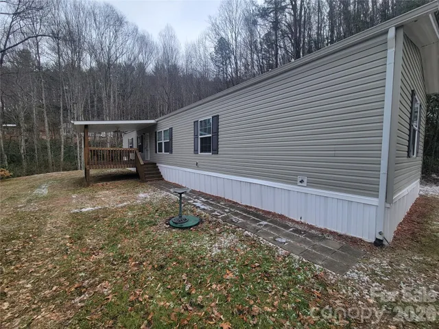 a backyard of a house with barbeque oven table and chairs