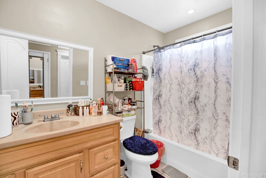 13666 Pinney Street Pacoima, CA 91331 - Photo 12 of 34 a bathroom with a sink a toilet and a shower