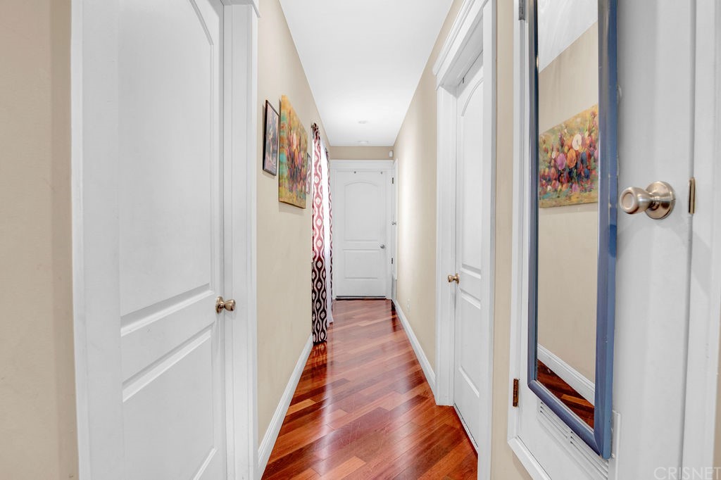 13666 Pinney Street Pacoima, CA 91331 - Photo 14 of 34 a view of a hallway with wooden floor and staircase