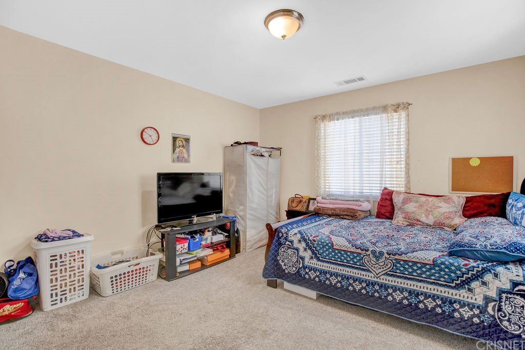 13666 Pinney Street Pacoima, CA 91331 - Photo 16 of 34 a living room with furniture and a flat screen tv