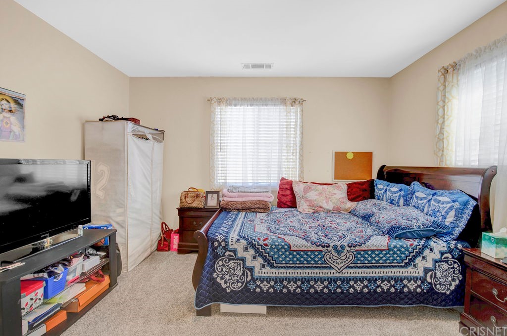 13666 Pinney Street Pacoima, CA 91331 - Photo 17 of 34 a bedroom with a bed and a flat screen tv