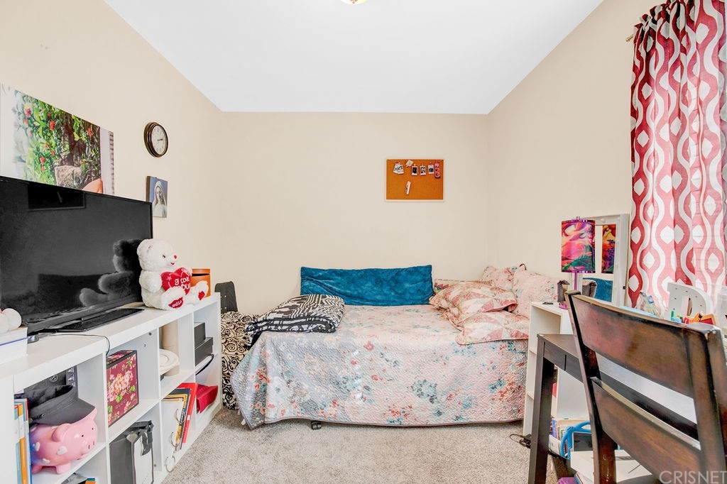13666 Pinney Street Pacoima, CA 91331 - Photo 20 of 34 a bedroom with a bed and a desk