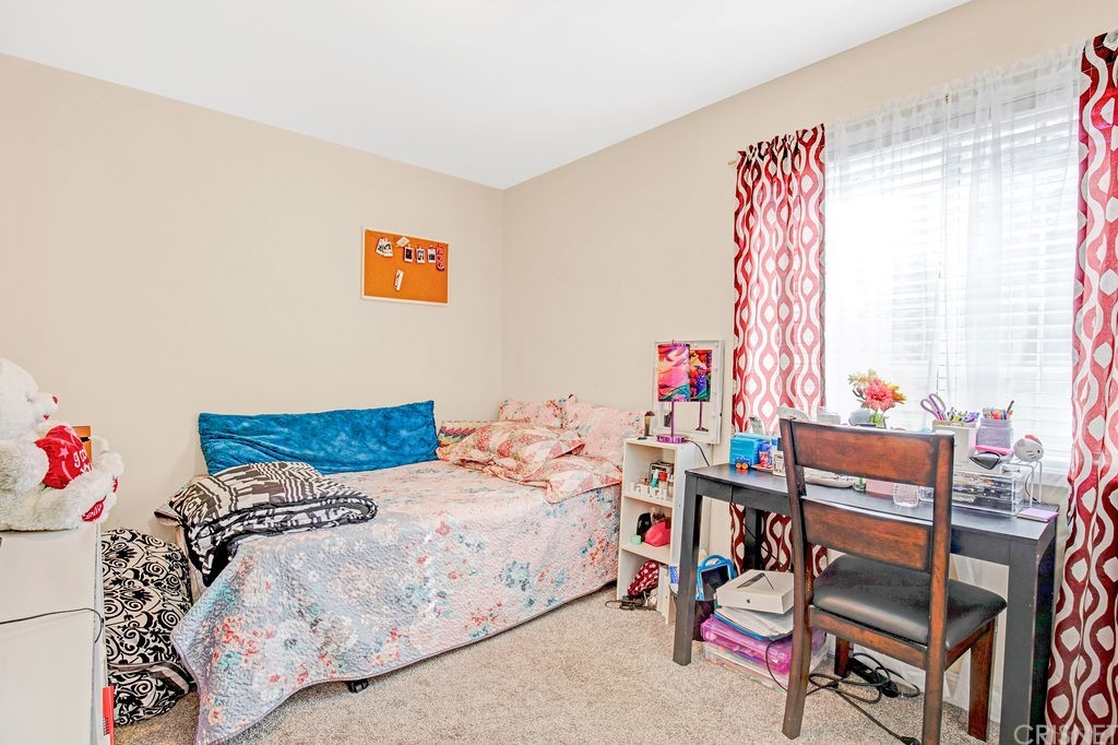 13666 Pinney Street Pacoima, CA 91331 - Photo 21 of 34 a bedroom with a bed and a window