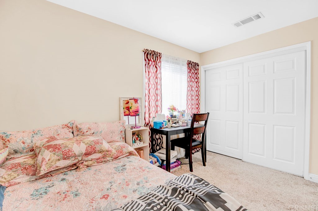 13666 Pinney Street Pacoima, CA 91331 - Photo 22 of 34 a bedroom with a bed and a table