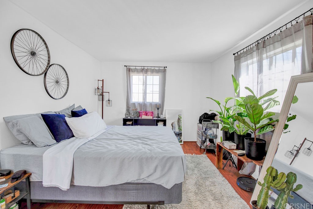 13666 Pinney Street Pacoima, CA 91331 - Photo 24 of 34 a bedroom with bed and a potted plant