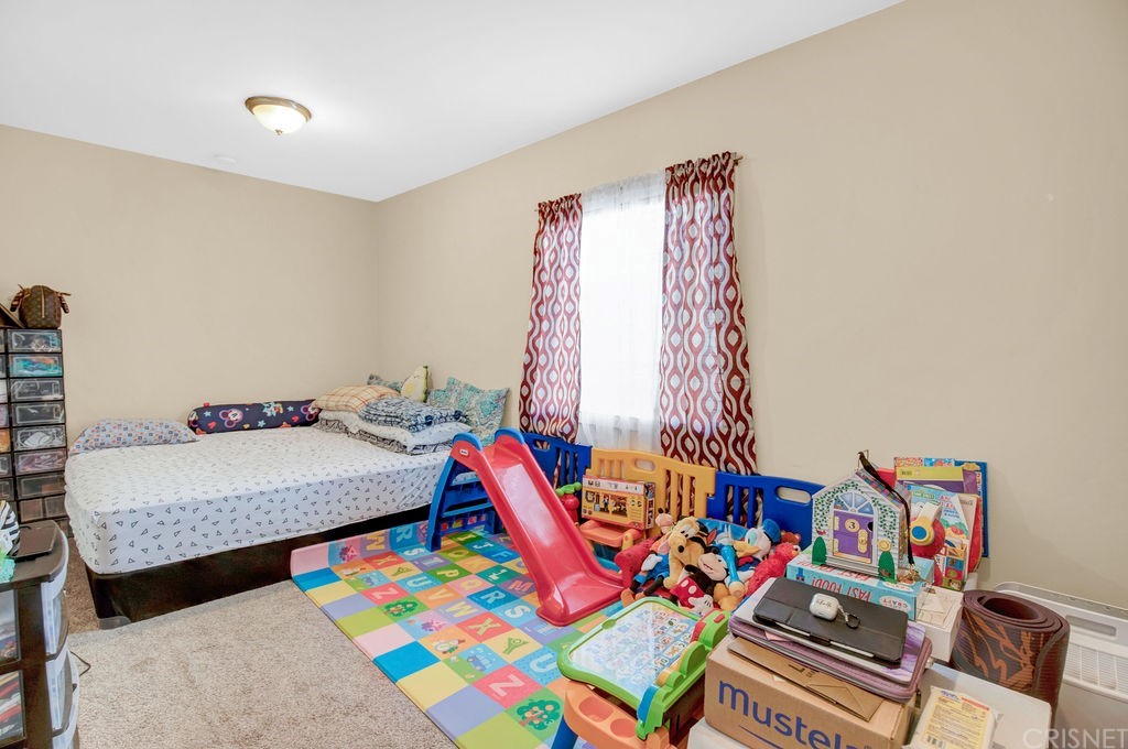 13666 Pinney Street Pacoima, CA 91331 - Photo 30 of 34 a living room with furniture and toys