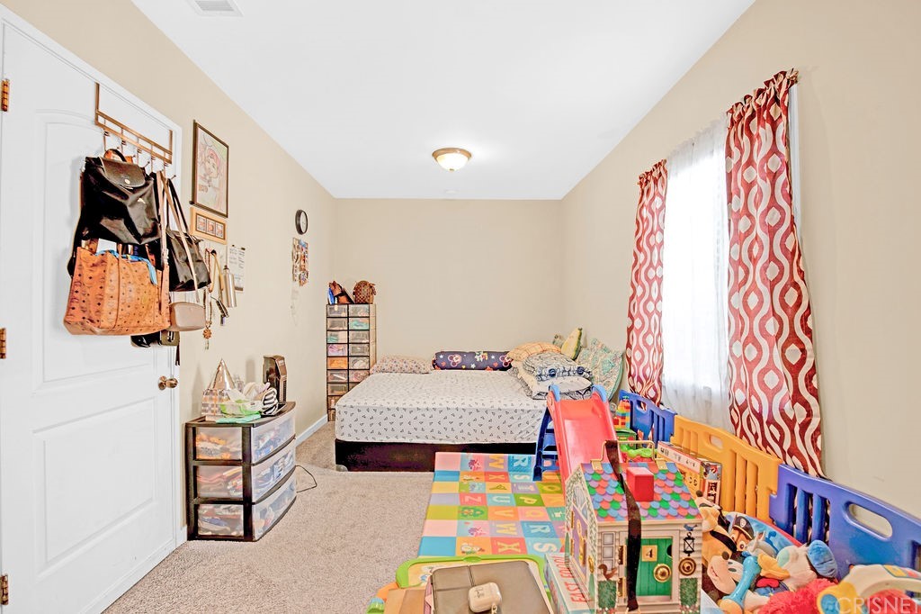 13666 Pinney Street Pacoima, CA 91331 - Photo 31 of 34 a bedroom with a bed and a painting on the wall