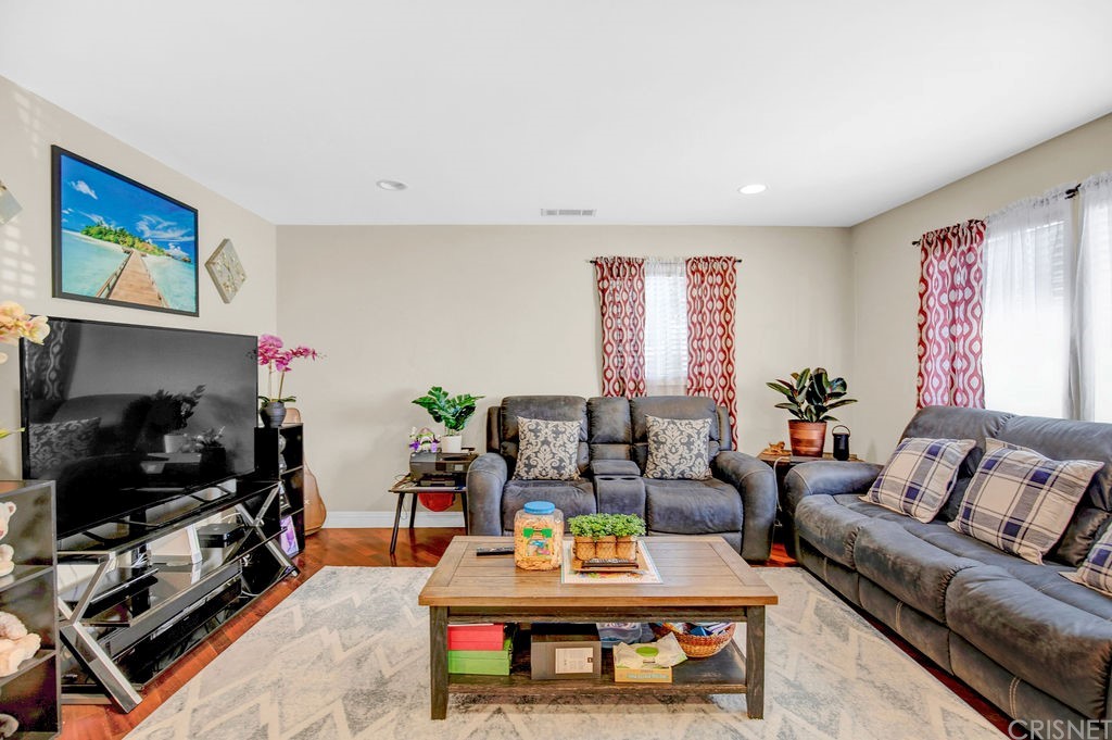 13666 Pinney Street Pacoima, CA 91331 - Photo 6 of 34 a living room with furniture a flat screen tv and a fireplace