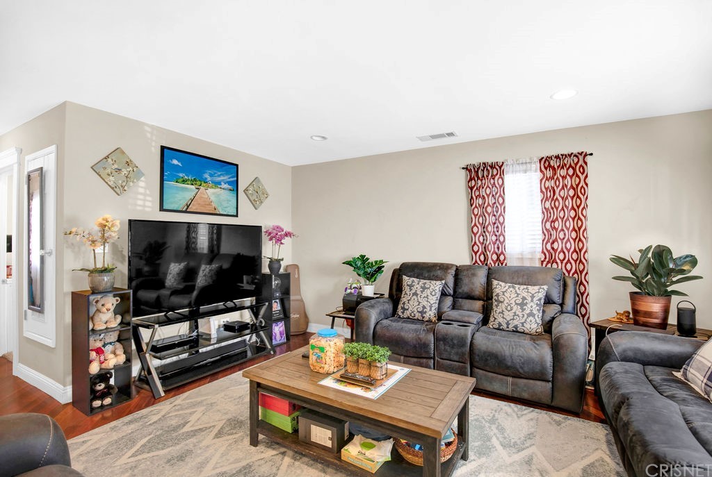 13666 Pinney Street Pacoima, CA 91331 - Photo 7 of 34 a living room with furniture and a flat screen tv
