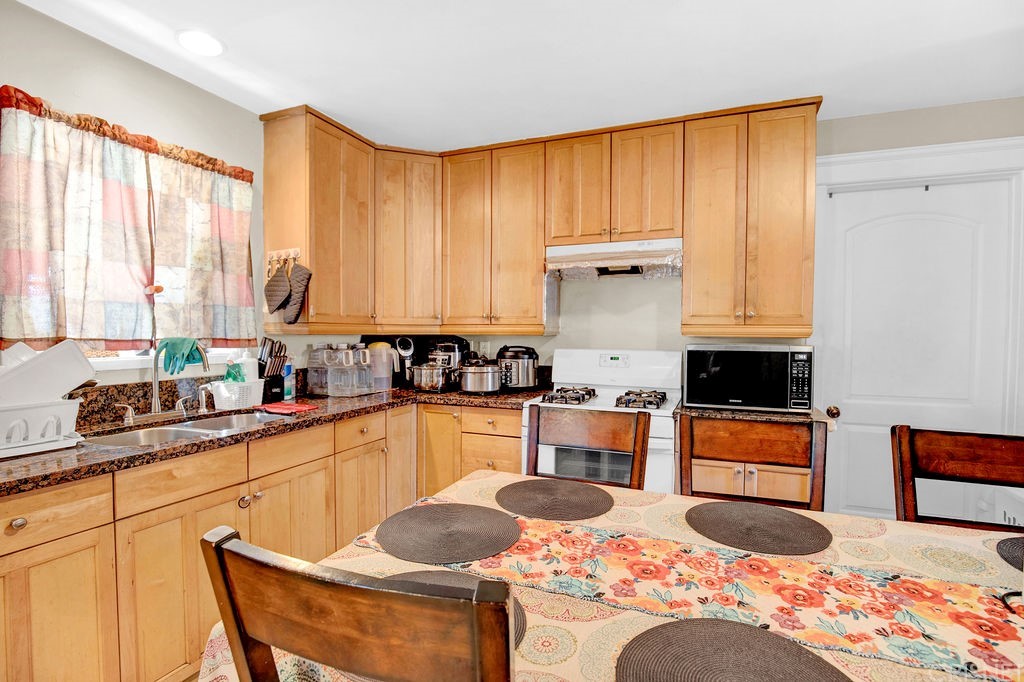 13666 Pinney Street Pacoima, CA 91331 - Photo 8 of 34 a kitchen with stainless steel appliances granite countertop a stove a sink and a microwave