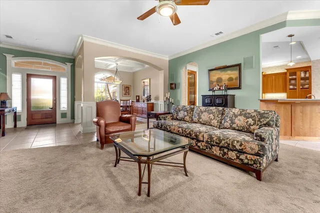 a living room with furniture and a chandelier