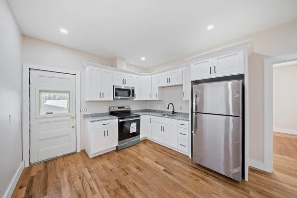 a kitchen with stainless steel appliances a refrigerator stove microwave and cabinets