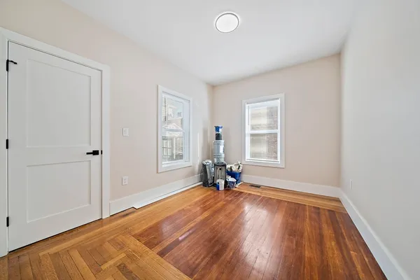 a view of a livingroom with wooden floor and a window